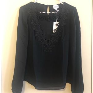 Black silk top with lace detail on neckline